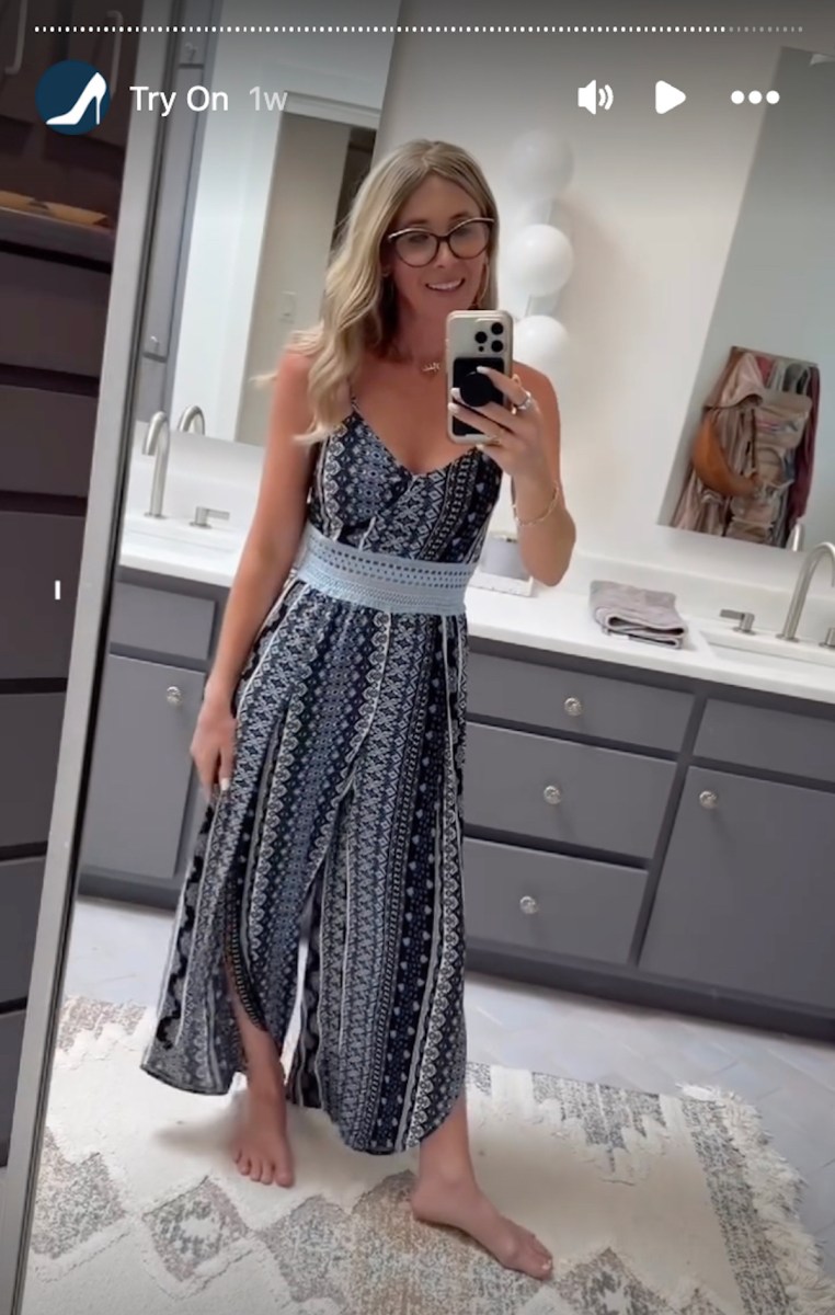 woman posting in jumpsuit in bathroom on instagram stories