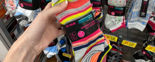 person in store holding up striped No Boundaries Womens Socks