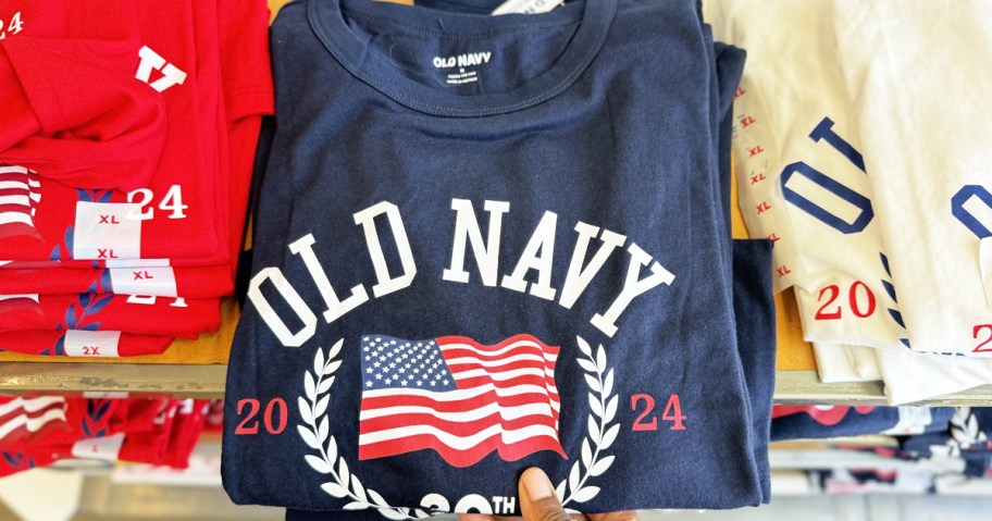 hand grabbing blue old navy flag tee from shelf