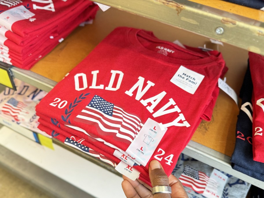 hand touching red old navy flag tee on shelf