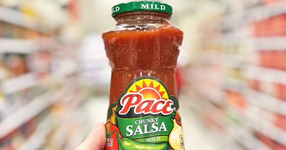 hand holding up a bottle of Pace Mild Chunky Salsa in store