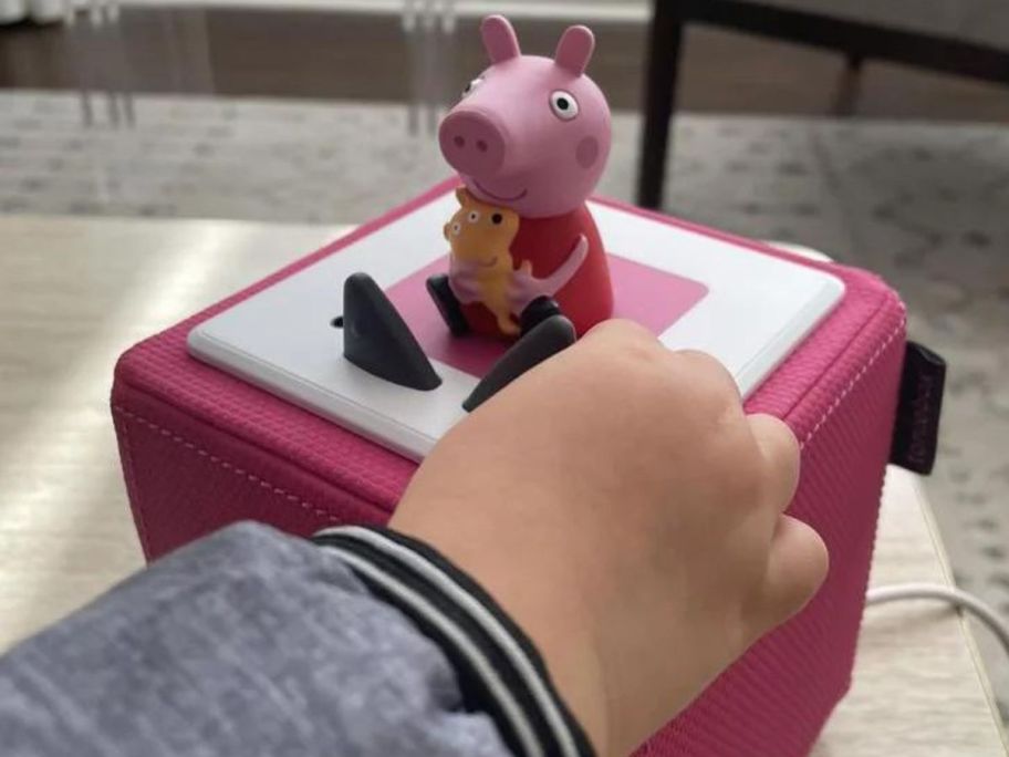 child playing with a Peppa Pig Toniebox