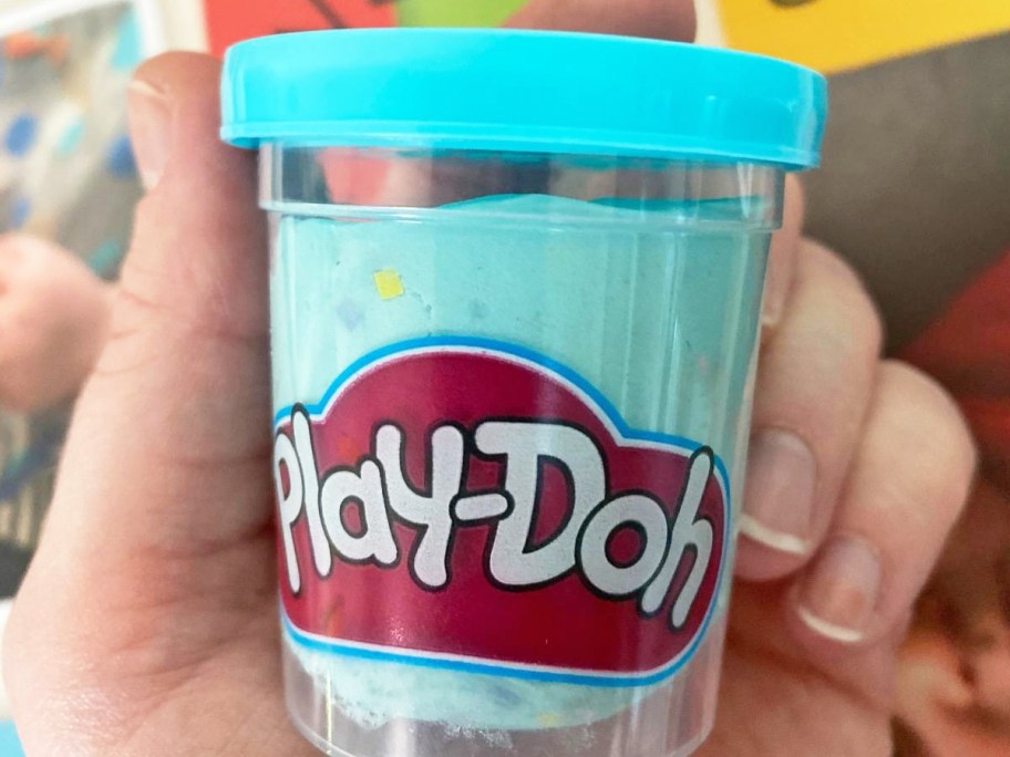 hand holding blue can of Play-Doh Confetti