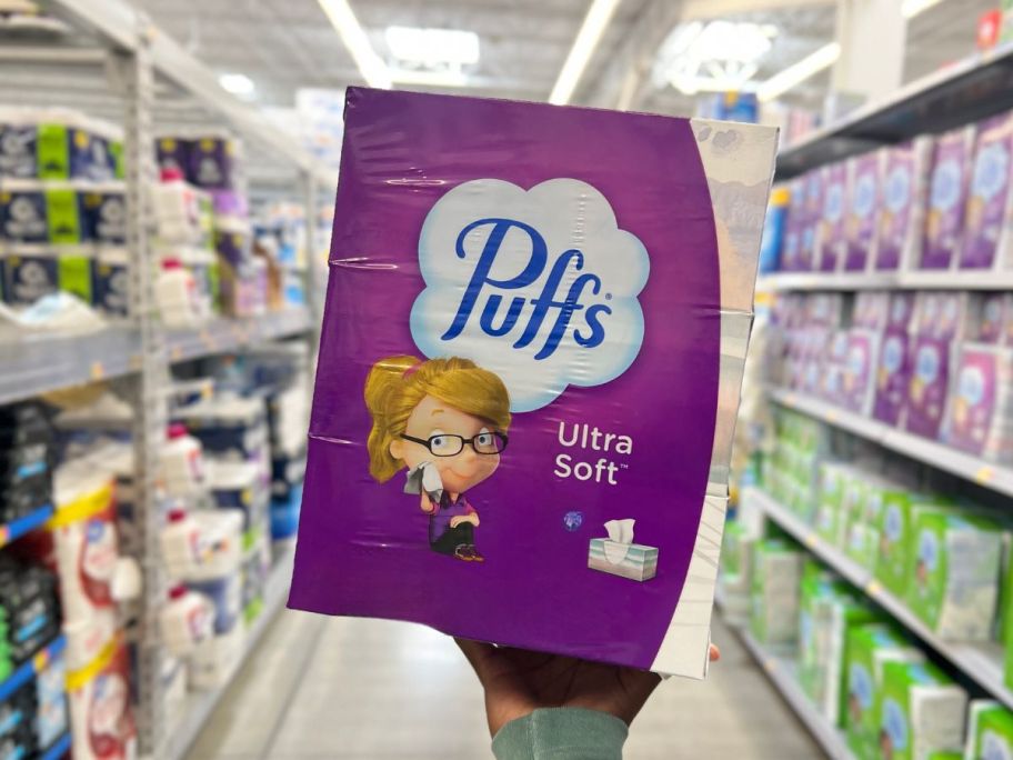 Puffs Ultra Soft Non-Lotion Tissues package being held by hand in store