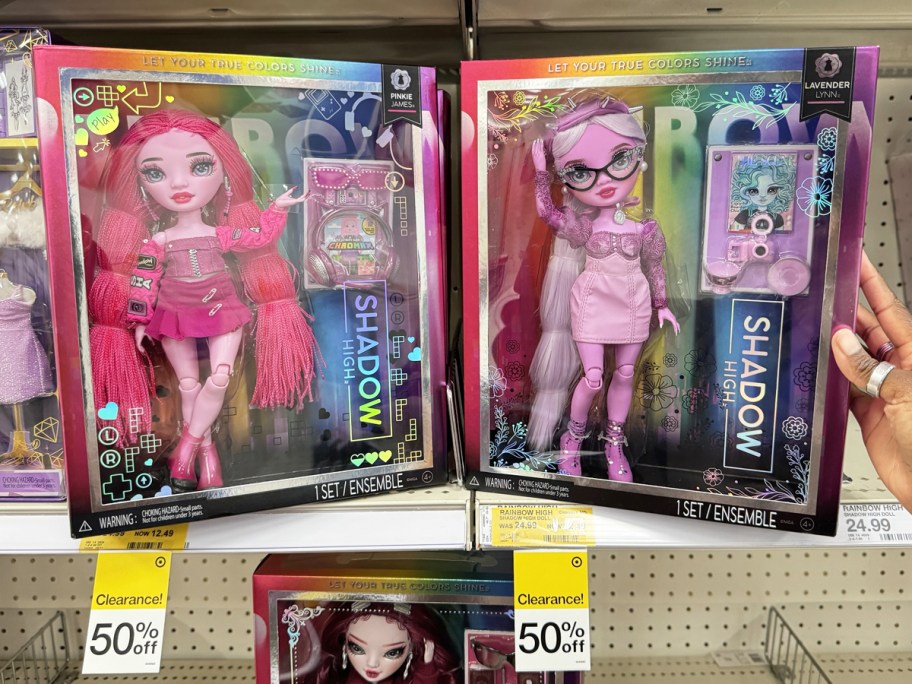 pink and purple Rainbow High Shadow High Dolls on store shelf with 50% off tags