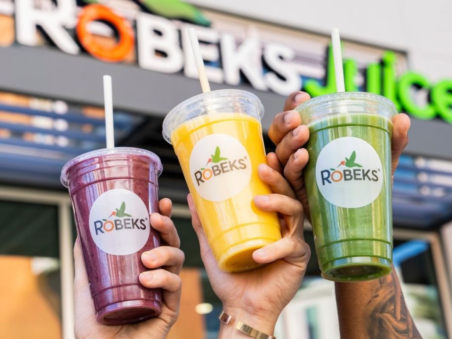 3 hands holding up Robeks Smoothies
