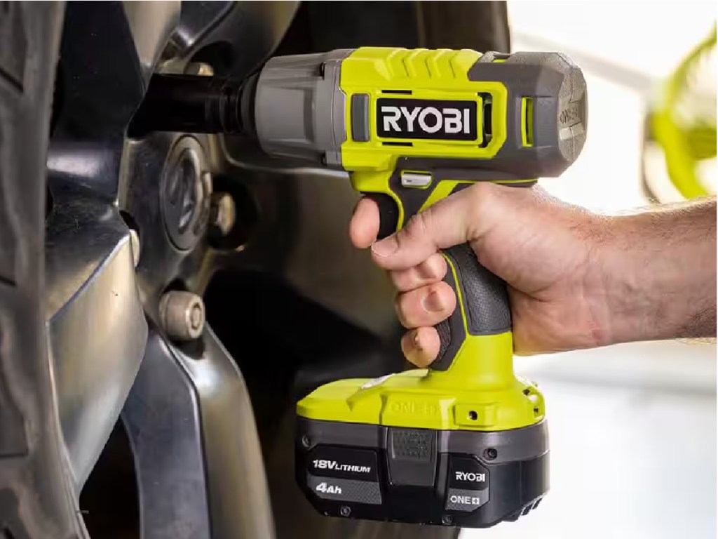 man using ryobi impact wrench with tire