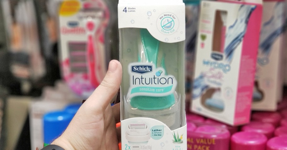 hand holding up a Schick Intuition Razor in store