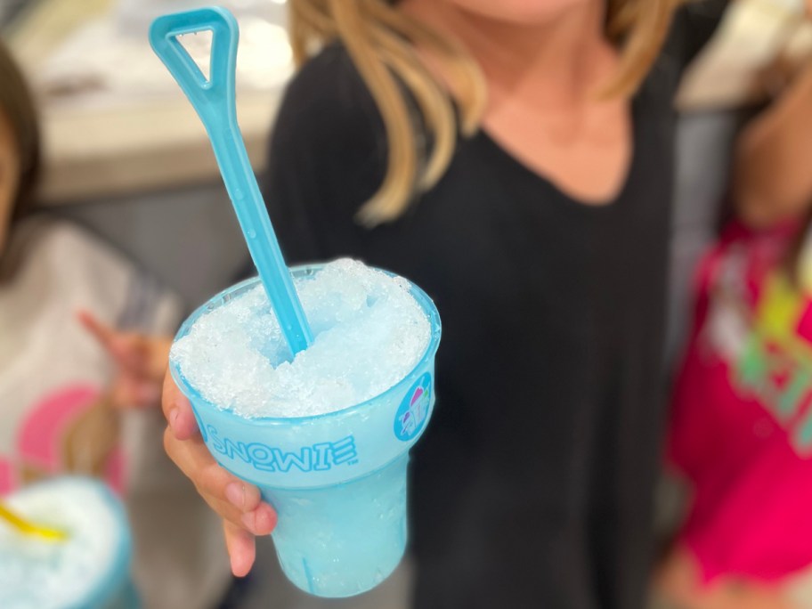 kid holding a snow cone