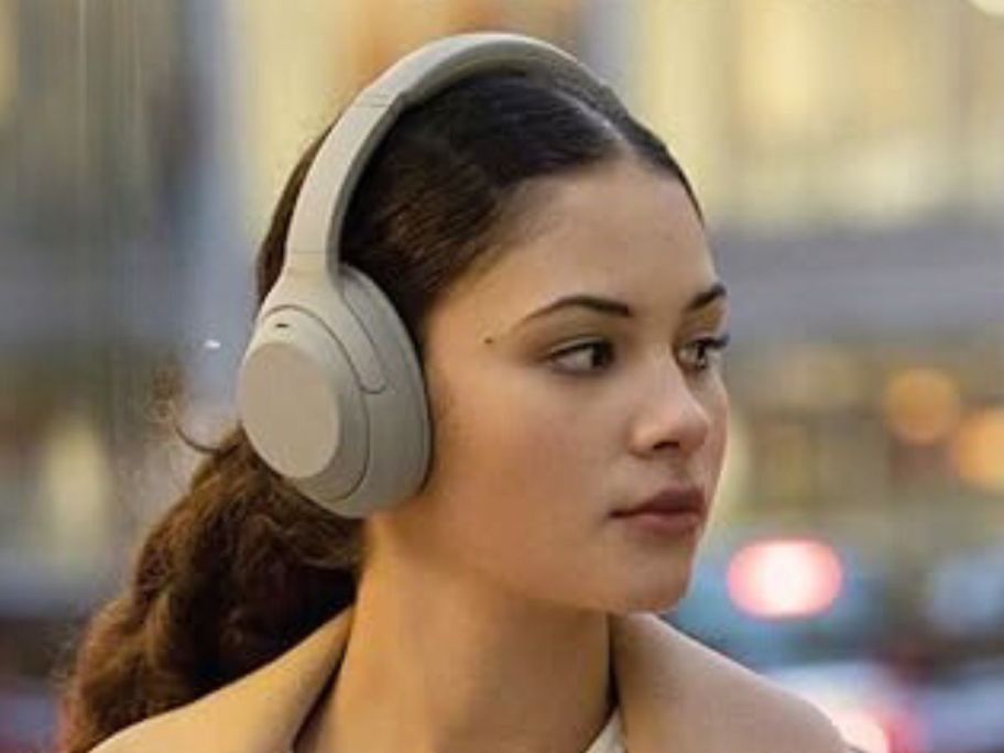 woman wearing Sony Wireless Premium Noise Canceling Overhead Headphones w/ Mic & Alexa Voice Control