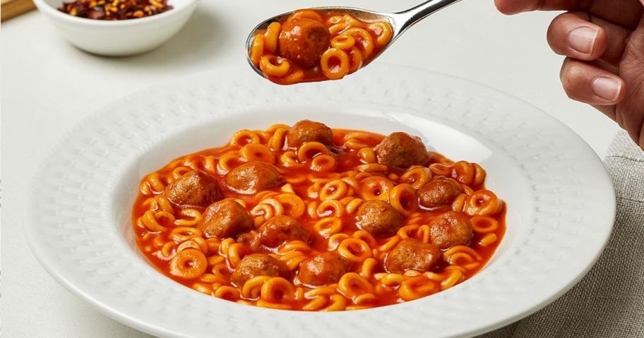 Spaghettios with meatballs in a bowl with a spoon