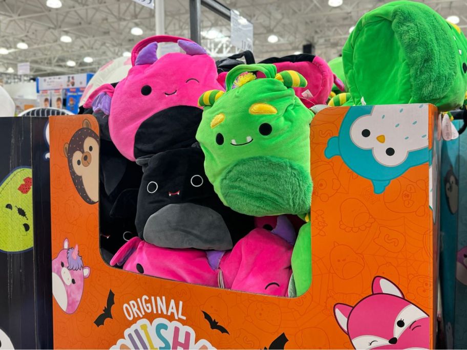 a bin filled with jumbo squishmallows treat pails in a costco club