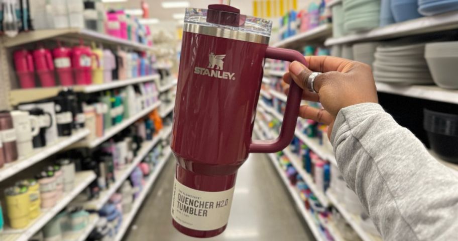 Stanley 40oz H2.0 Flowstate Quencher Tumbler being held by hand in aisle in store