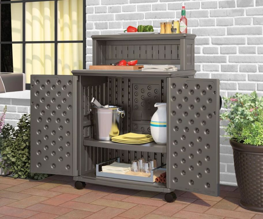 a gray patio storage and grilling prep station on a patio next to a window