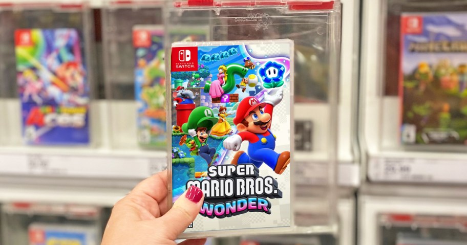hand holding up Super Mario Bros. Wonder Video Game in store