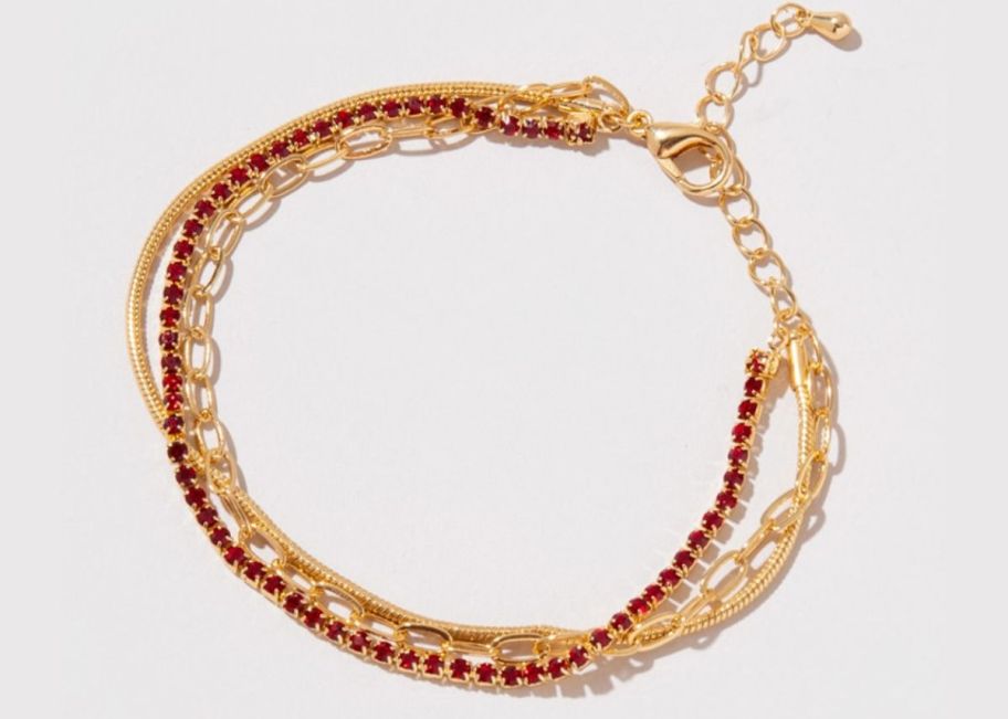 a gold 3 layer snake bracelet with red stones