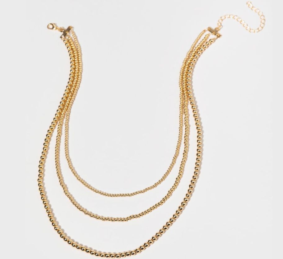 a gold multi chain layerred necklace