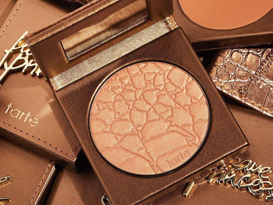 close-up shot of opened tarte bronzer in a pile of other bronzers