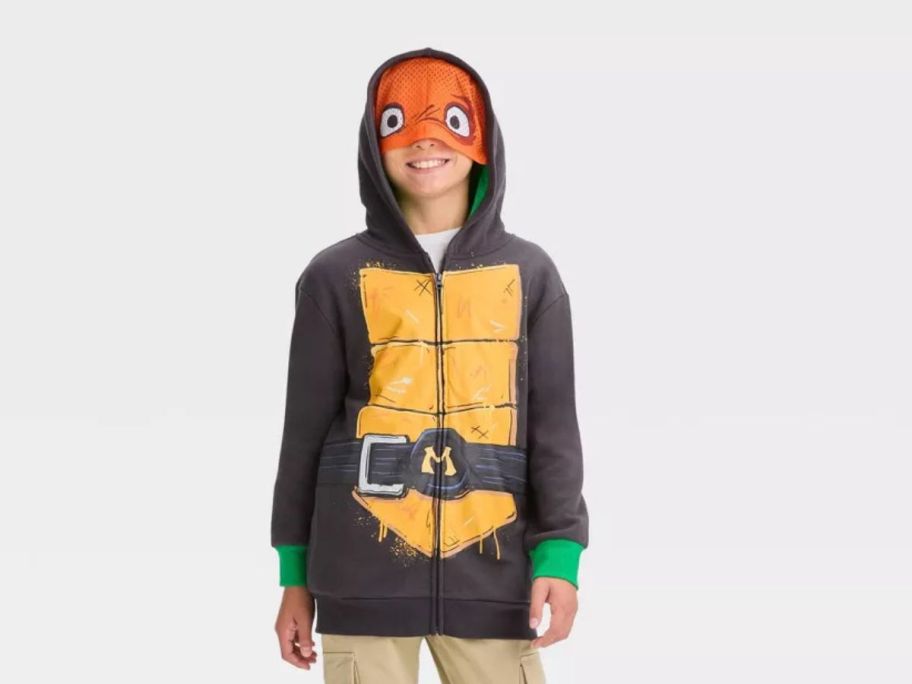 boy wearing Teenage Mutant Ninja Turtles Michelangelo Sweatshirt