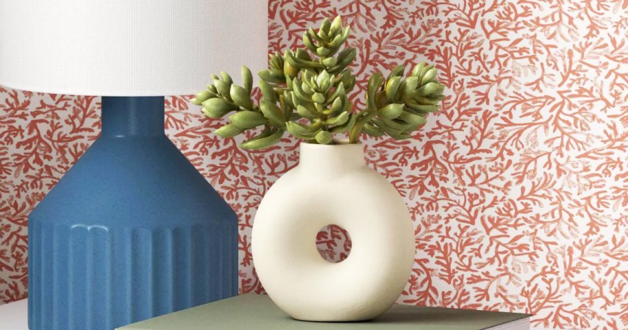 plant stem bundle in a white circle vase on nightstand