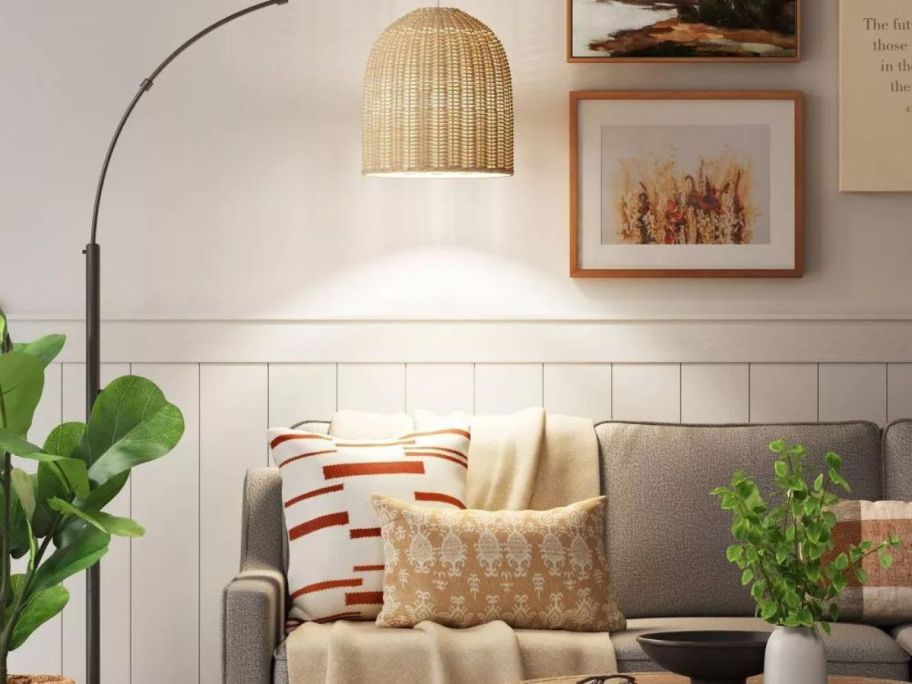 A Threshold Rattan Lamp over a couch in a living room