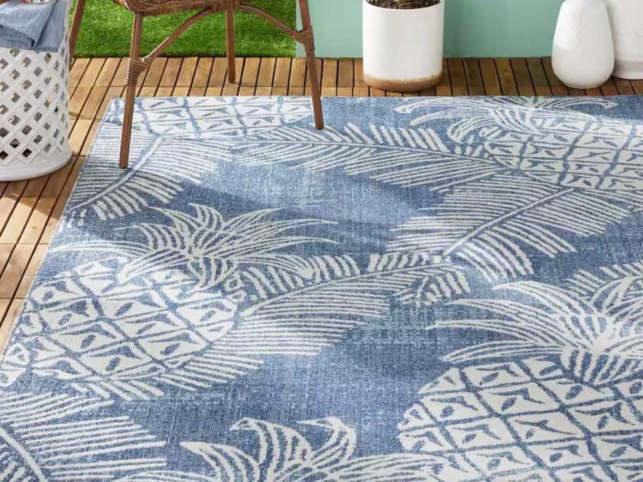 blue and white pineapple print area rug on patio