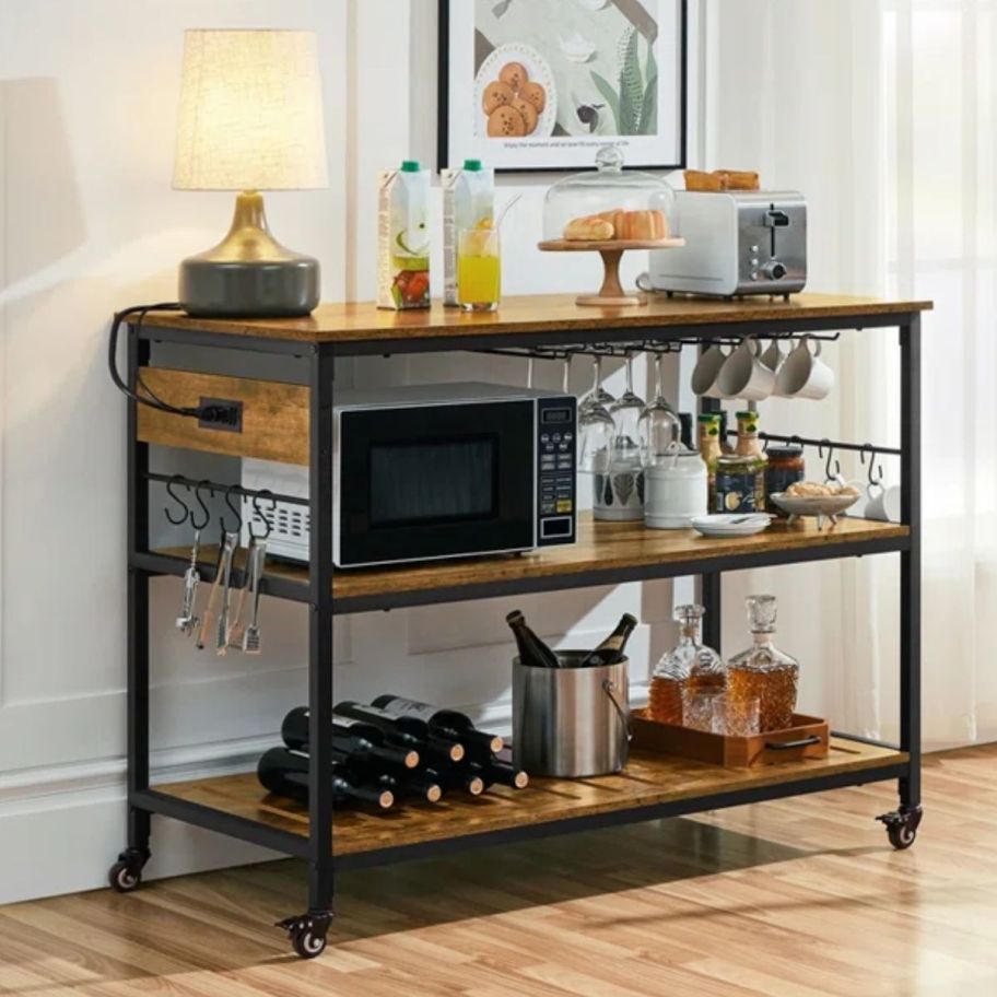 an iron rolling kitchen cart shown with bar items 