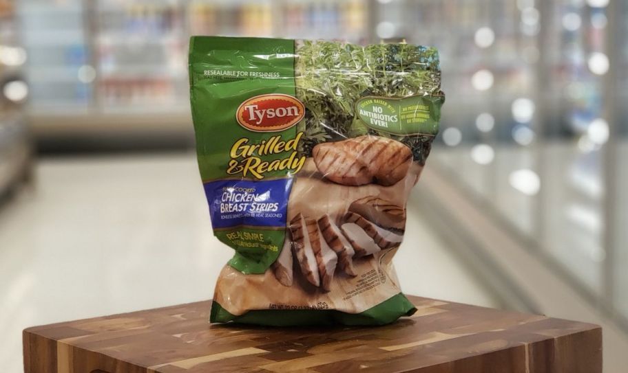 a bag of tyson frozen chicken breast strips in a grocery store