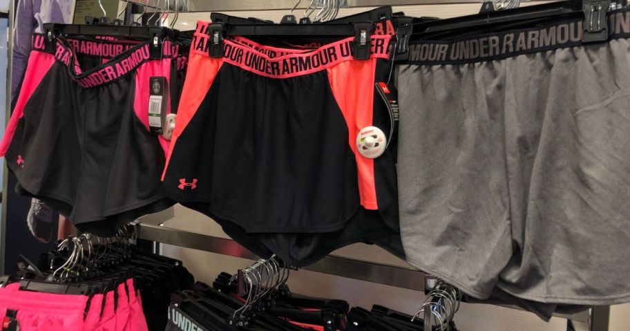 Under Armour shorts hanging on rack in store