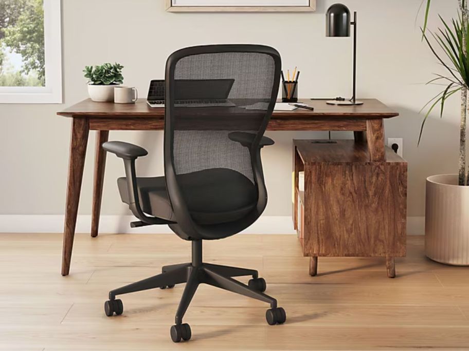Union & Scale™ MidMod 60"W Computer and Writing Storage Desk with chair in front of it and plants and office supplies on top