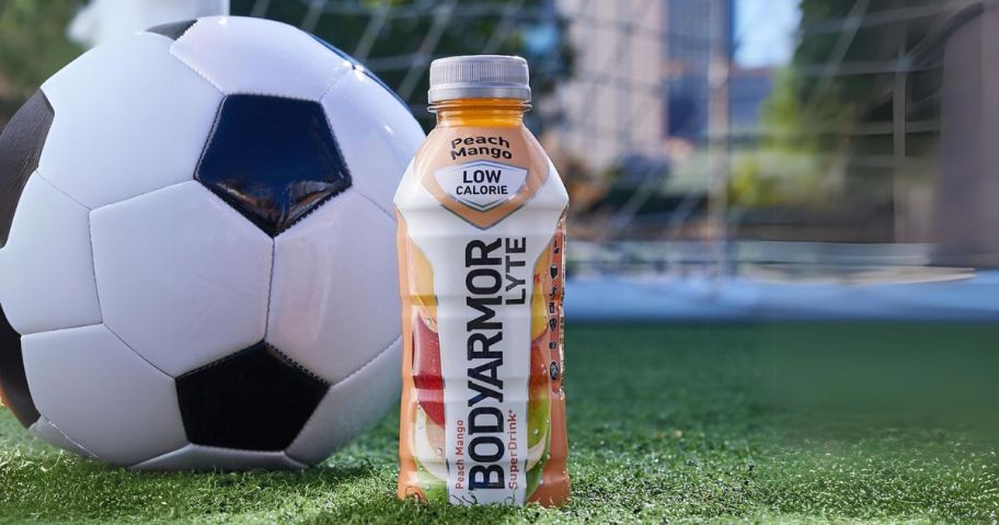 BodyArmor Lyte Sports Drink 12oz Bottle in front of soccer ball