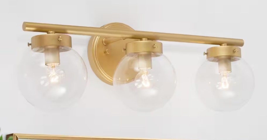 gold vanity light with 3 glass orbs