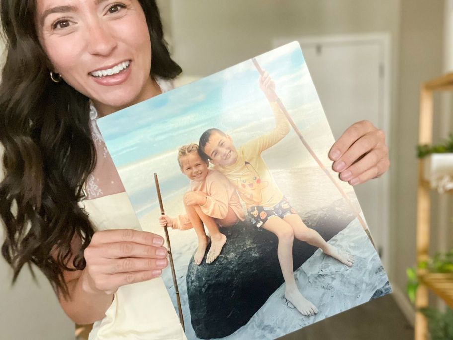 Woman holding a Walgreens metal photo print