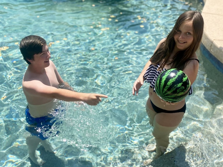 Kids playing with watermelon ball in pool