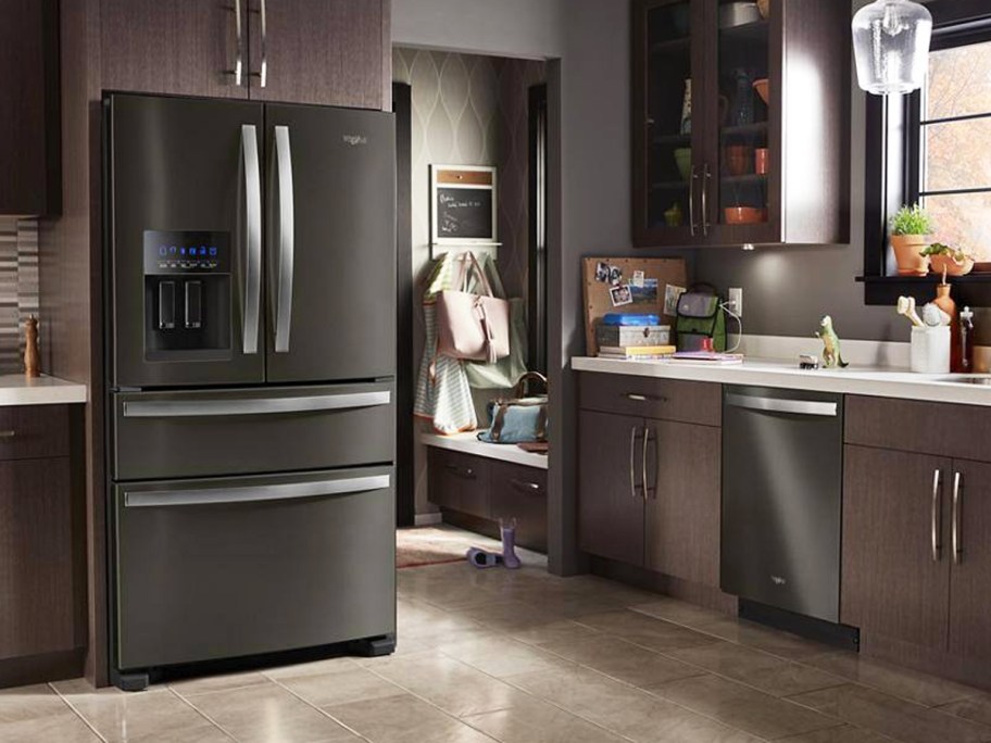 black stainless steel fridge and dishwasher in dark kitchen