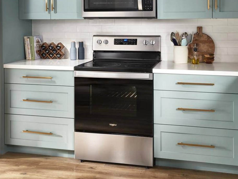 Whirlpool range & air fryer oven in kitchen with blue cabinets