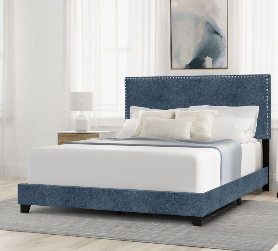 a blue denim upholstered nail head headboard