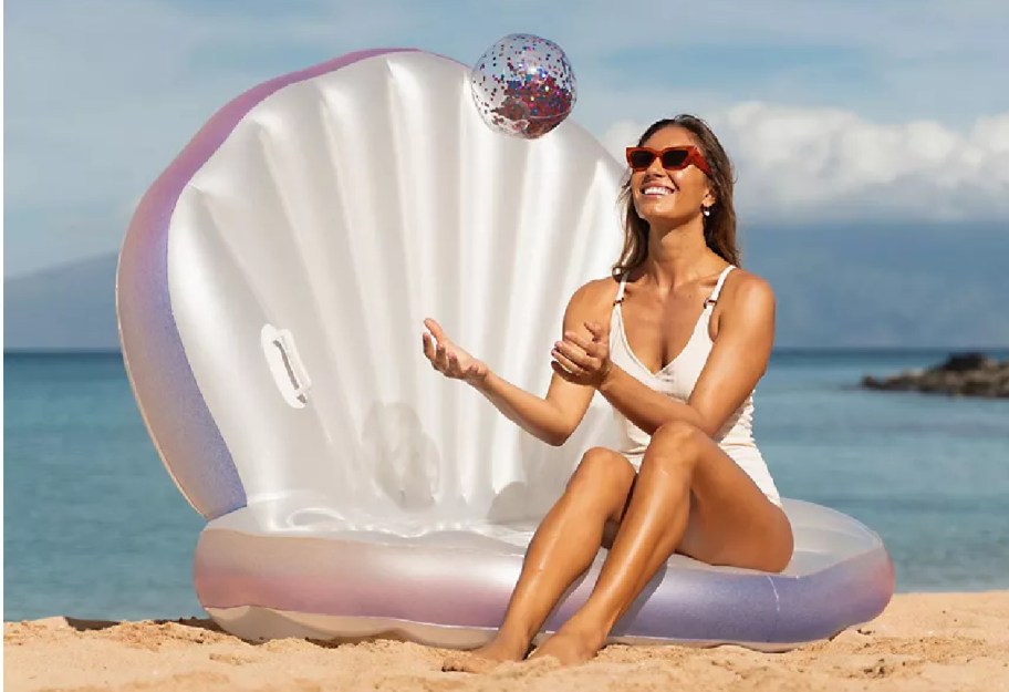 Woman sitting on sea shell float