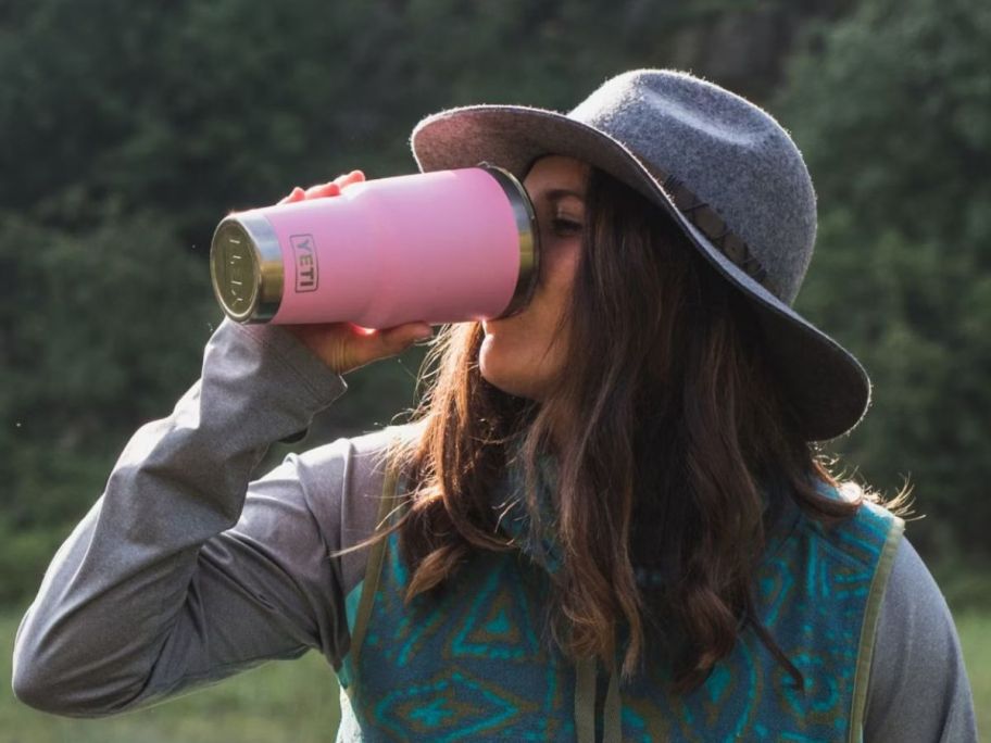 Woman drinking from a Power Pink Rambler Tumbler