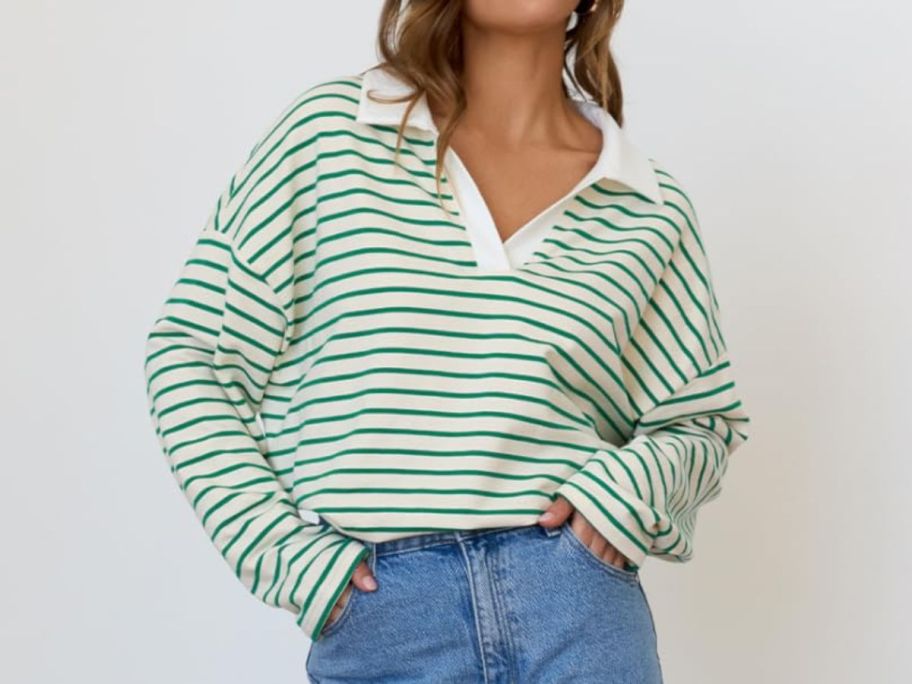A woman wearing a green and white striped long-sleeved shirt