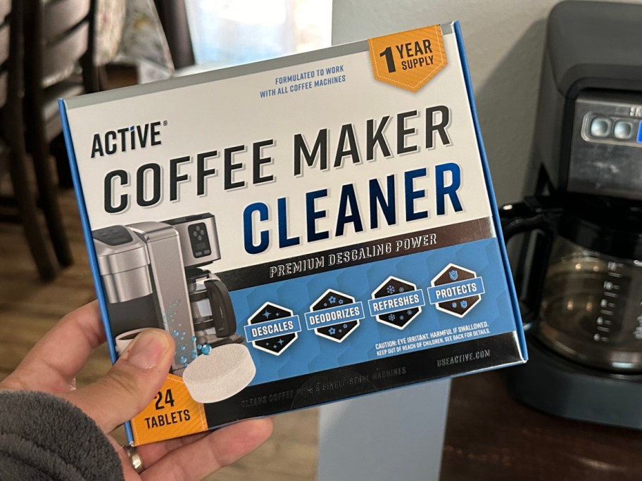 hand holding active coffee cleaner box