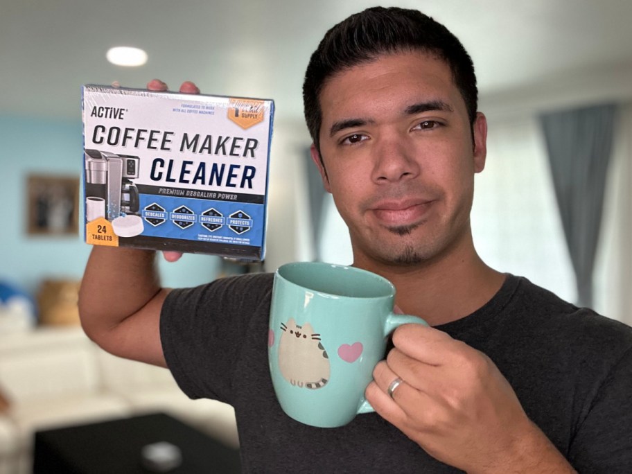 man holding coffee maker cleaner and mug