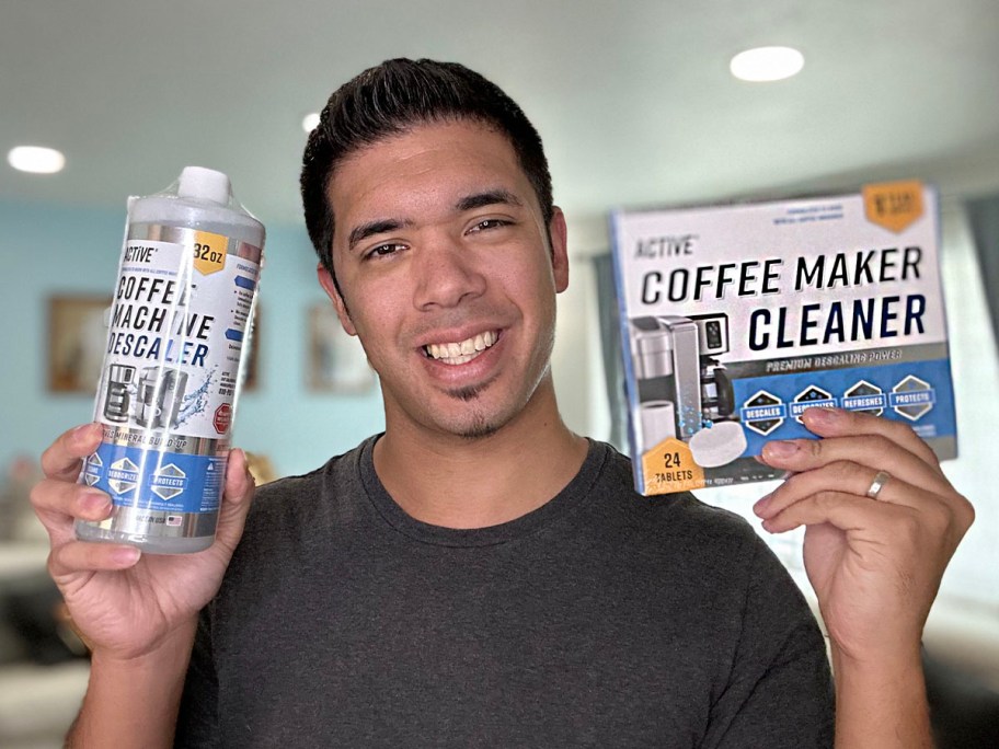 man holding coffee maker cleaner and descaler 