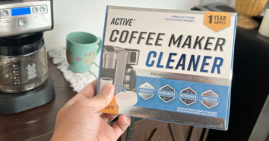 hand holding active coffee maker cleaner