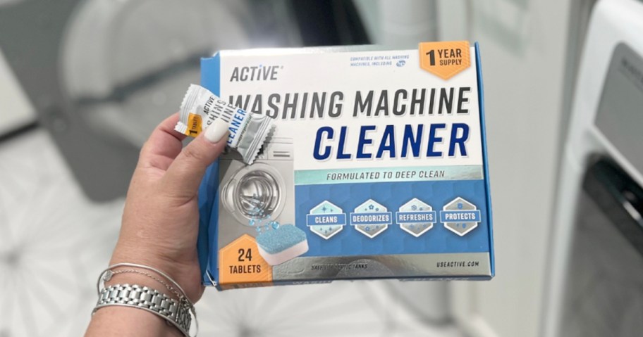 hand holding washing machine cleaner box with packet