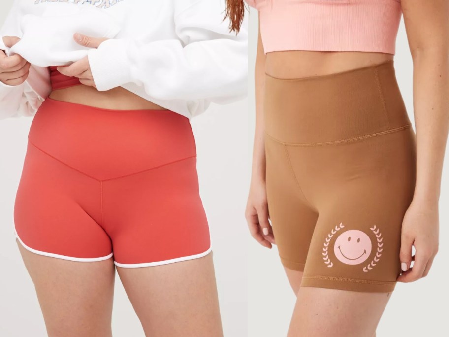 women wearing bike shorts, 1 in orange with white piping and 1 in brown with a pink smiley face