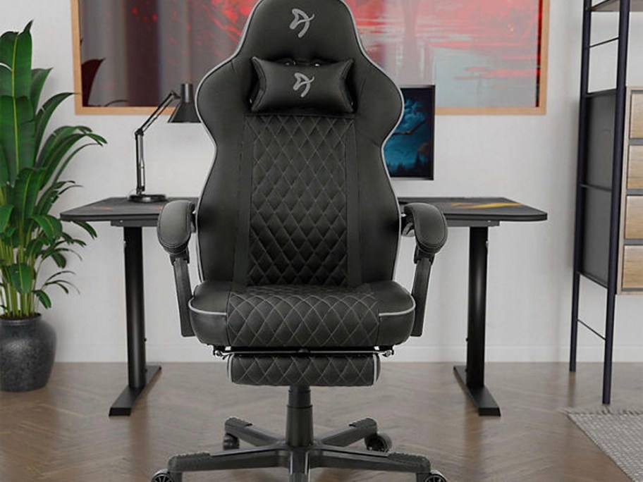 black gaming chair sitting in front of computer desk 