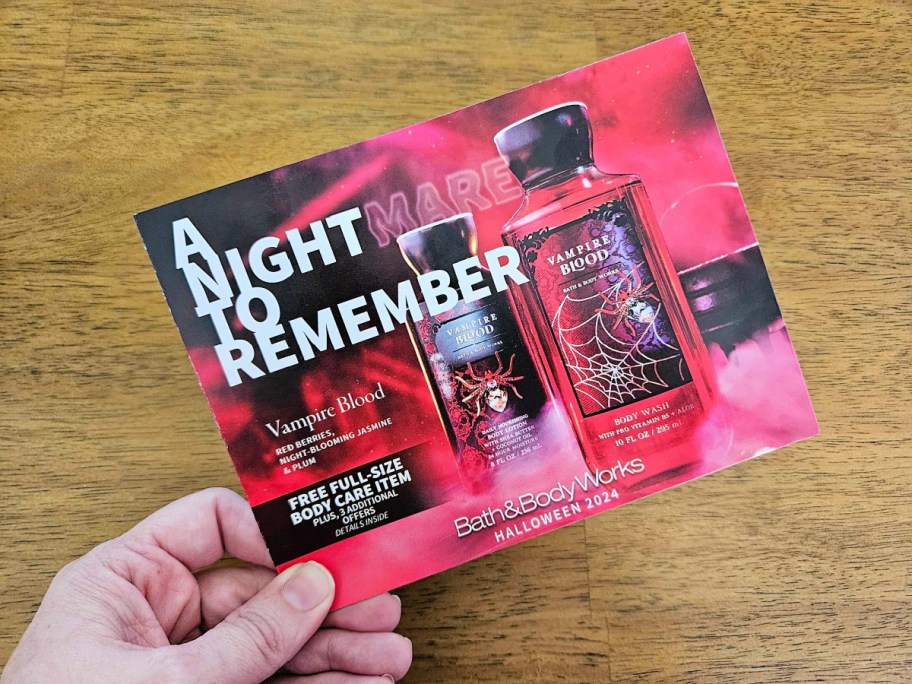 hand holding the bath and body works halloween coupon mailer