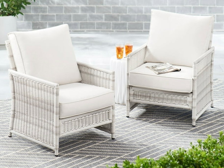 white lounge chairs with cushions on patio on gray rug