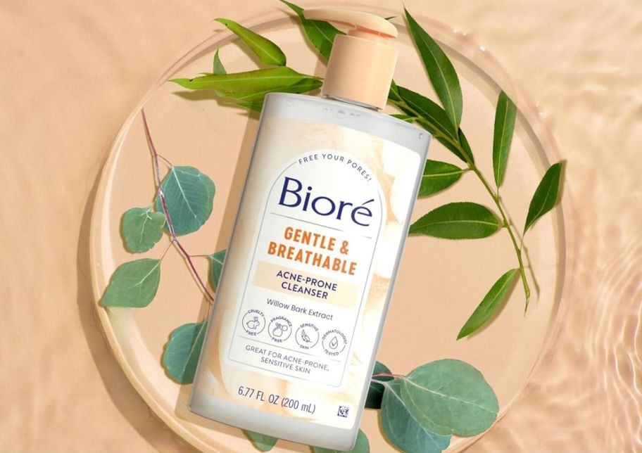 a bottle of biore gentle and breathable cleanser for acne prone skin shown with botanical leaves